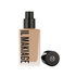 A bottle of IL Makiage Woke Up Like This Flawless Base Foundation with the cap removed, showing the medium shade foundation liquid.

