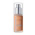 A pump bottle of Revlon Illuminance Liquid Foundation in a shade named 'Brulee', which is a translucent container showing the light-colored foundation inside.