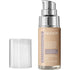 A pump bottle of Revlon Illuminance Skin-Caring Foundation in a Cool Beige shade, with the cap detached and placed next to it.